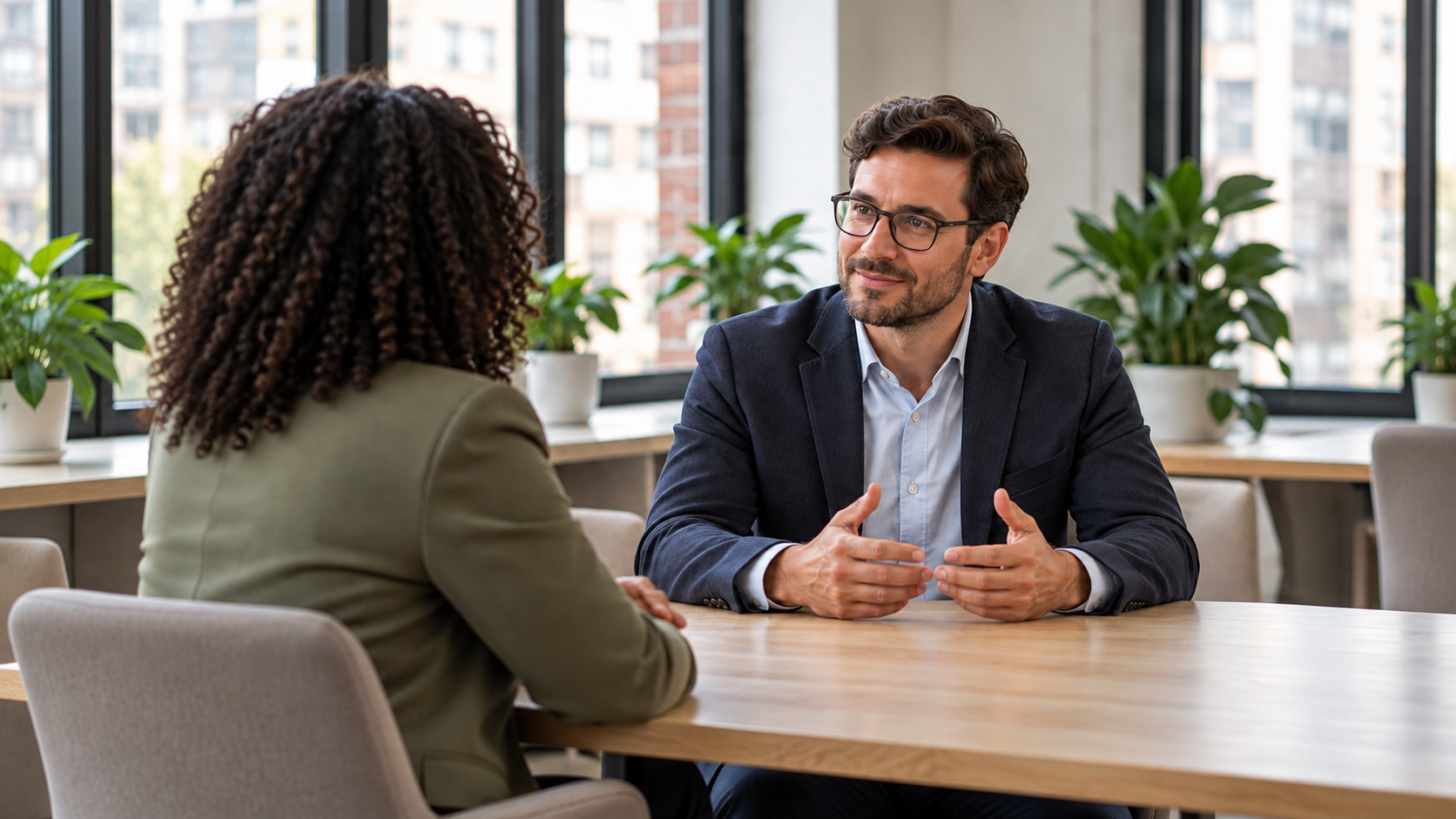 Two professionals sharing a workplace conversation across a table